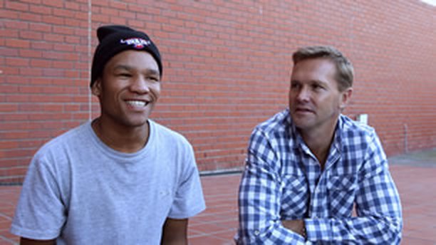 A mentor and mentee sitting together outdoors